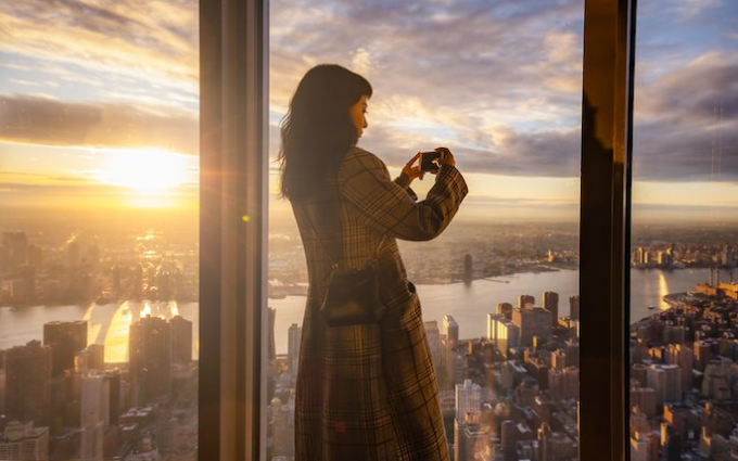 Person taking photo at sunset