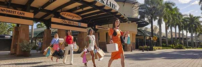 Shoppers leave a store with bags