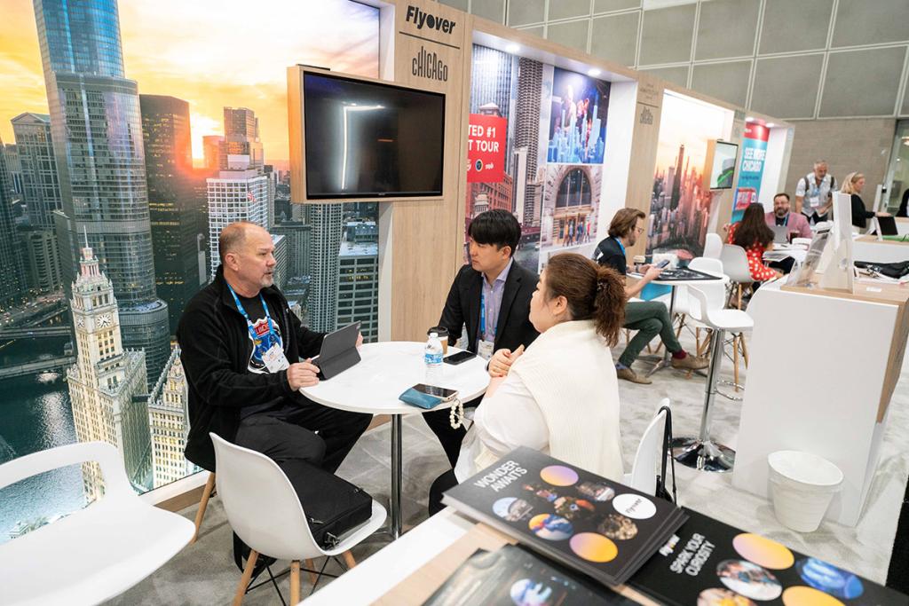 Attendees meeting with skyline background