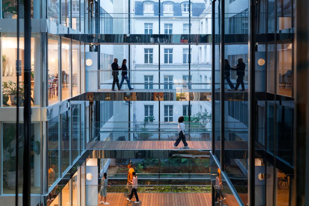 People walking across an office building